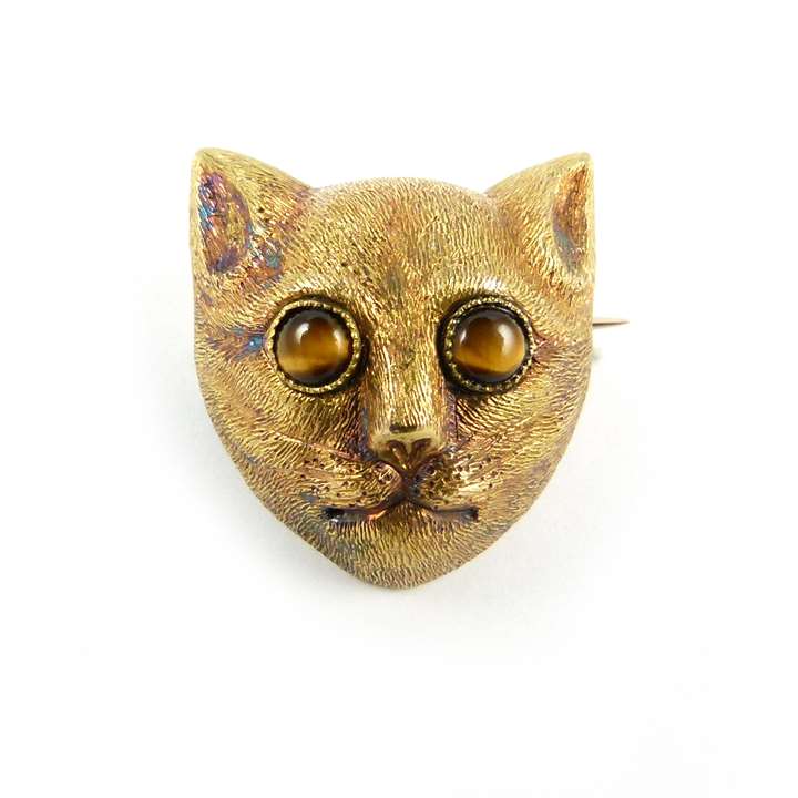 Antique textured gold cat's head brooch with tiger's eye set eyes